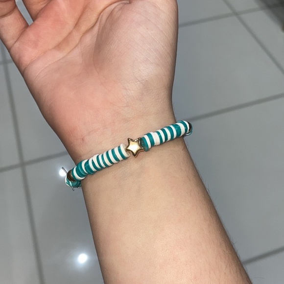 A beautiful blue and white bracelet with gold star and circle beads. Stretchy. - Picture 2 of 3